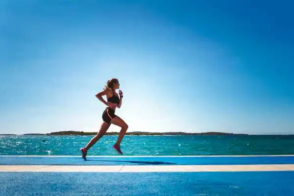Woman running showing strong leg muscle Stockwood
